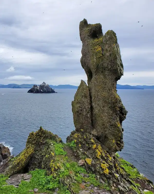 Tall rock pinnacle on Skellig Michael, with Little Skellig in the sea behind