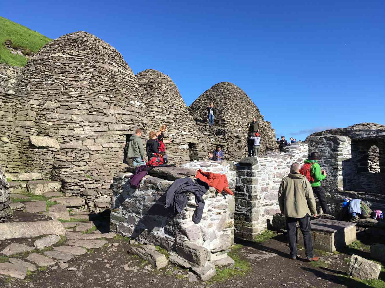 Ancient beehive huts on Skellig Michael monastery viewed from boat tour